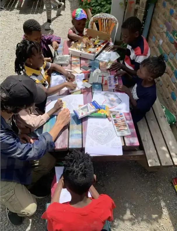 Refugee children taking part in a creative art activity with an adult at Imece's educational program in Turkey.